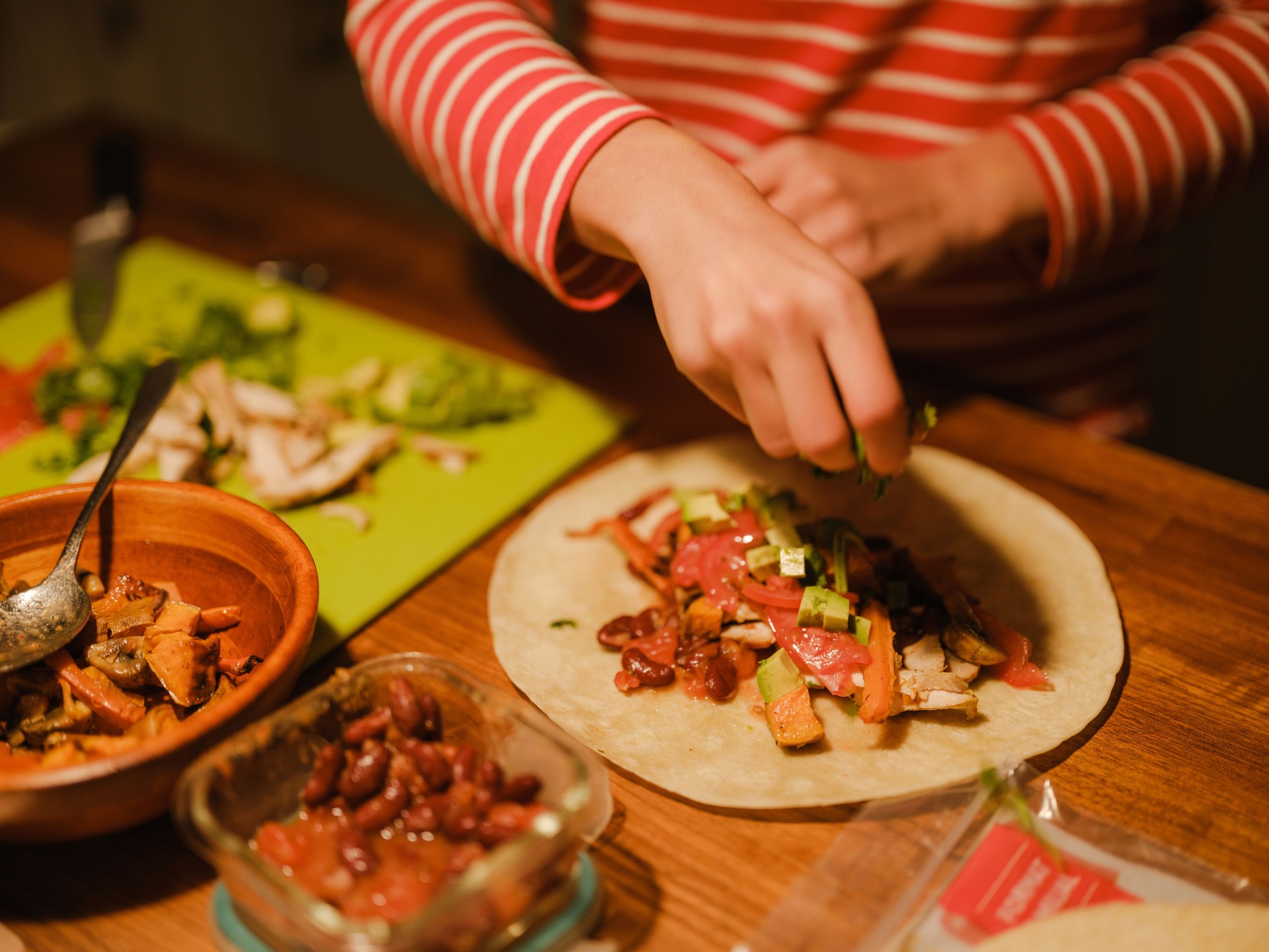 Woman cooking burrito for dinner